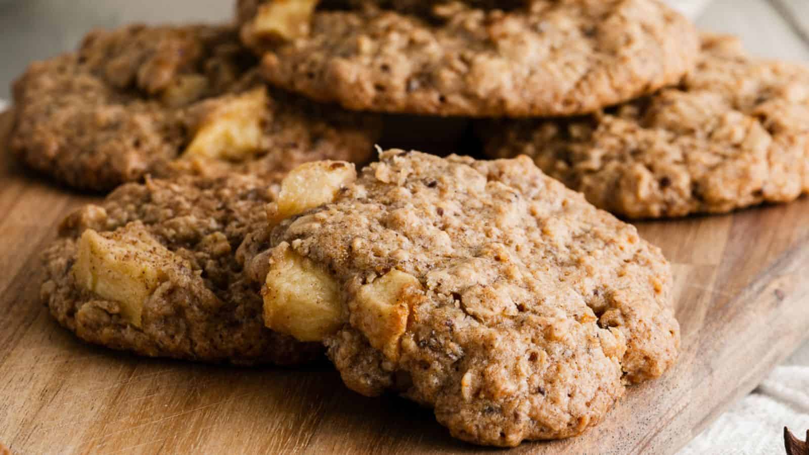 Close-up of vegan apple cookies with oatmeal on a wooden board.