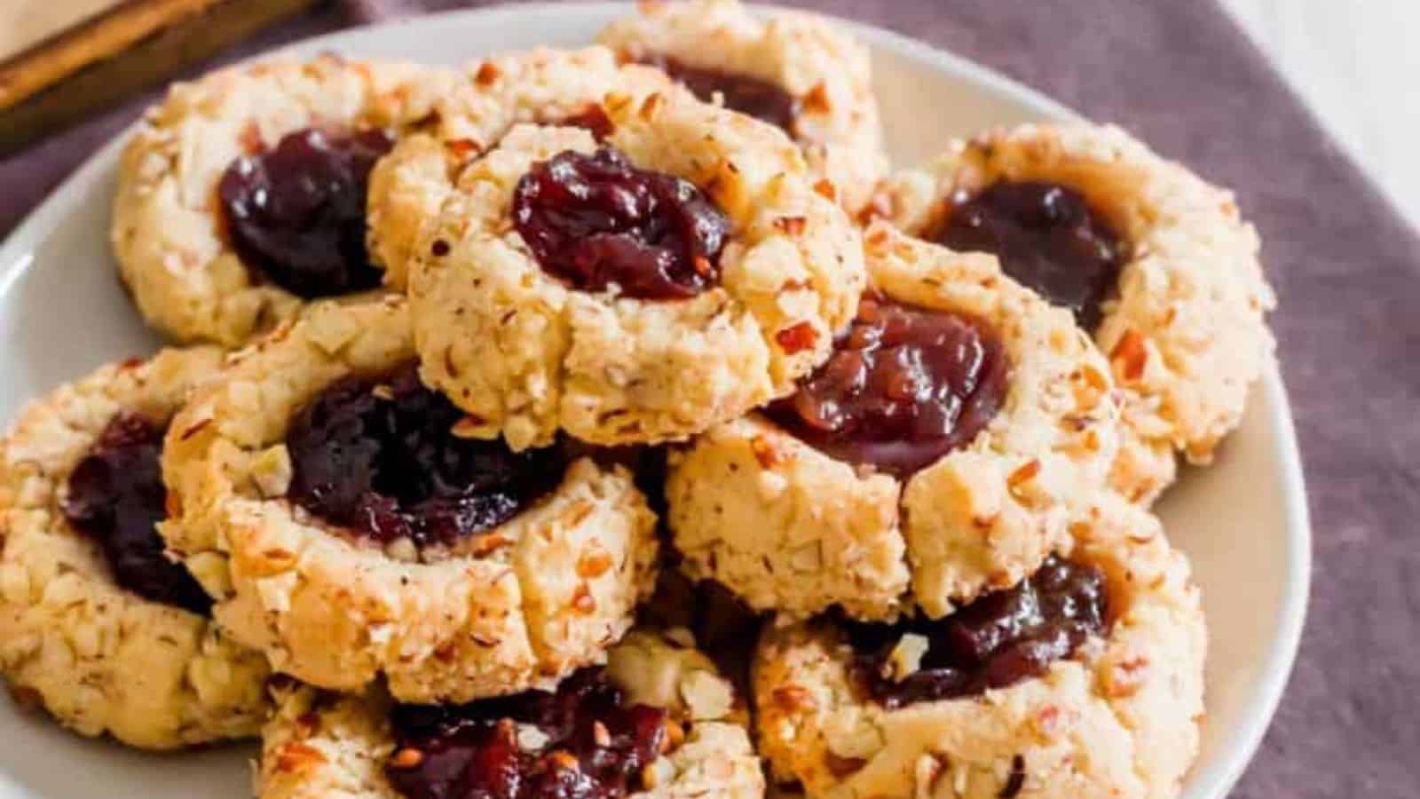 Close-up of a stack of vegan thumbprint cookies in a plate.