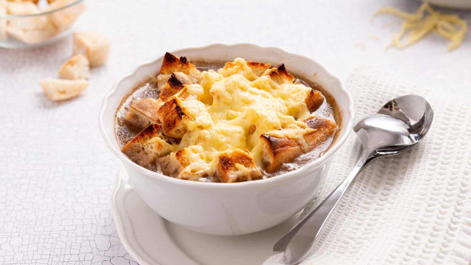 An image of vegetarian French onion soup in a bowl.