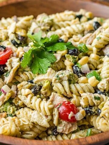 Close-up image of zesty tex mex chicken pasta salad in a brown bowl.
