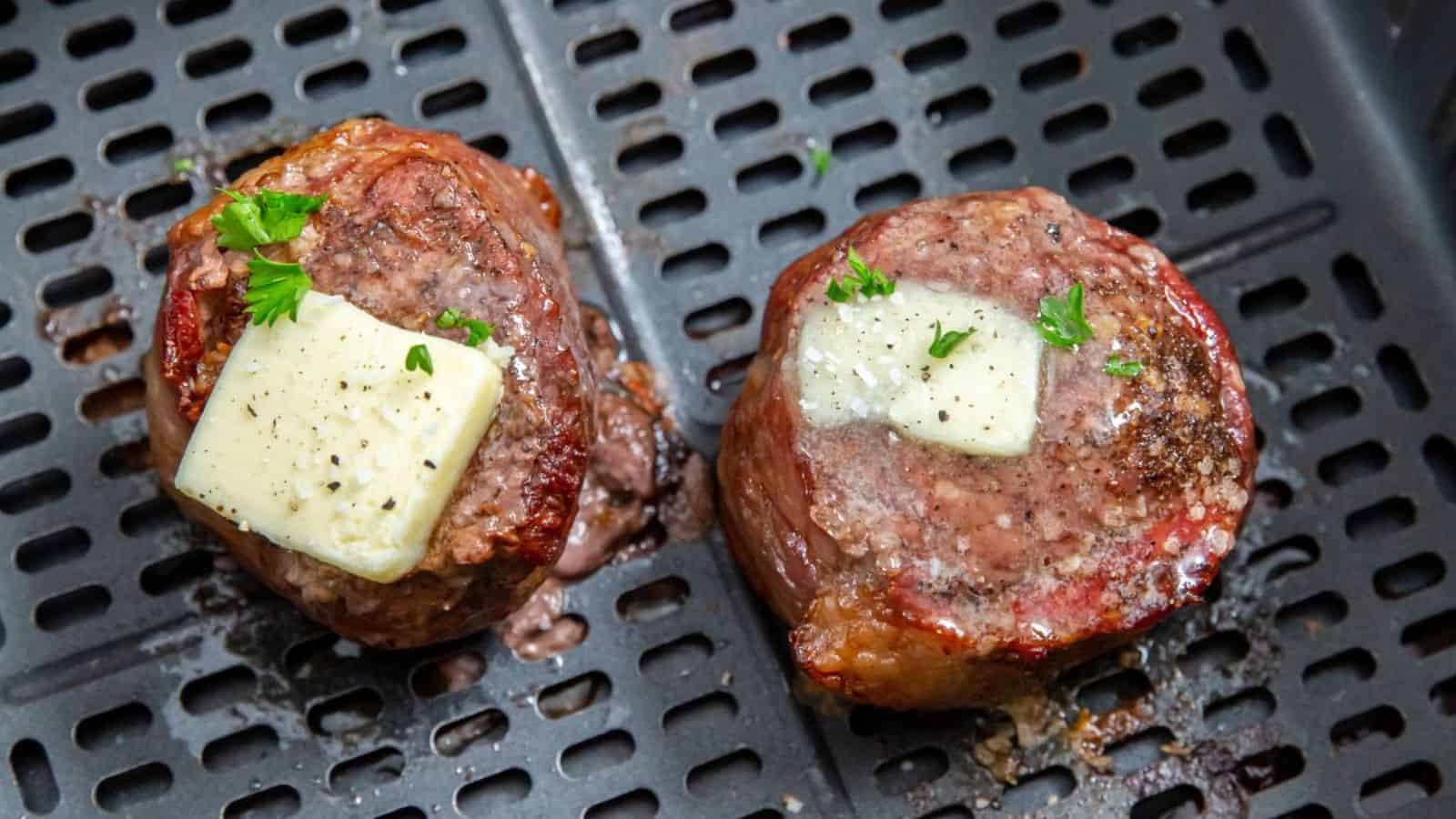 Air Fryer Bacon Wrapped Chuck Tender Filet on a what plate with mashed cauliflower, butter, parsley, pepper, and salt.