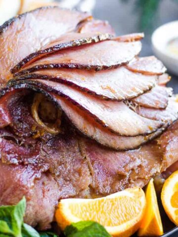 Sliced ham with oranges and mint.
