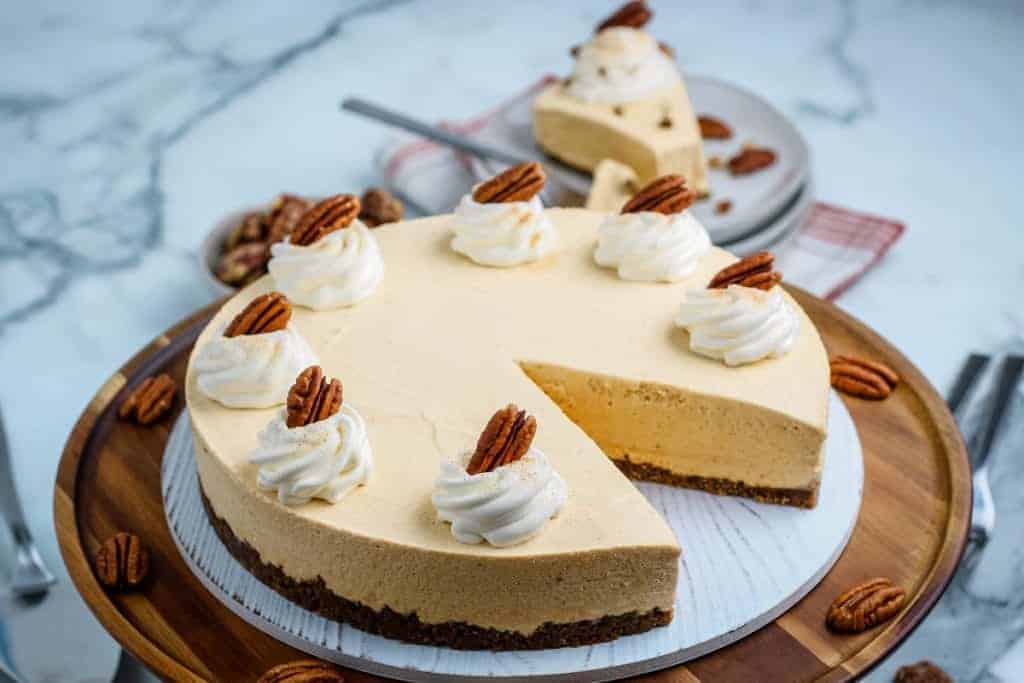 No Bake Pumpkin Cheesecake topped with whipped cream and pecans.