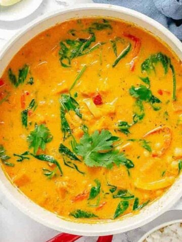 Overhead shot of a white pot with Thai pumpkin curry.