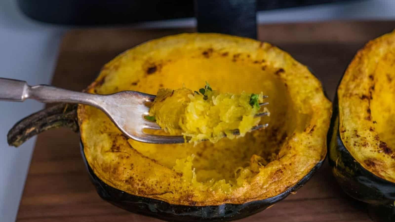 Acorn squash after air frying with some of the insides scooped up on a fork.