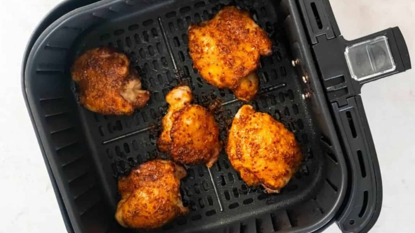 Top view of air fryer boneless chicken thighs.