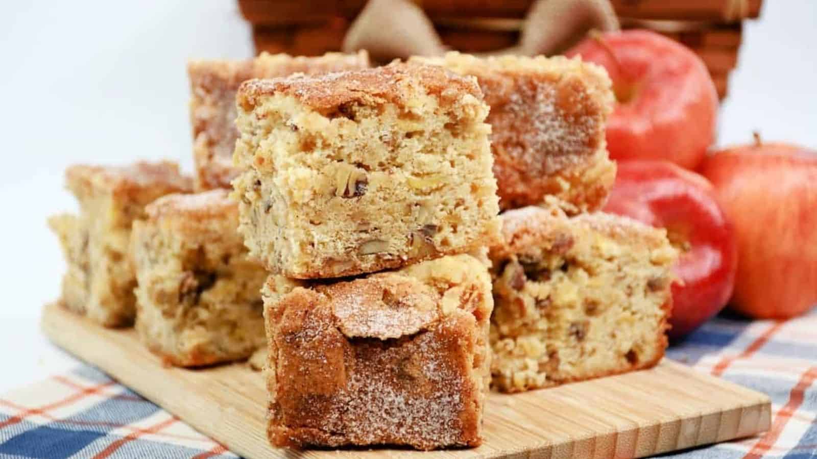 A stack of apple cake on a wooden cutting board.