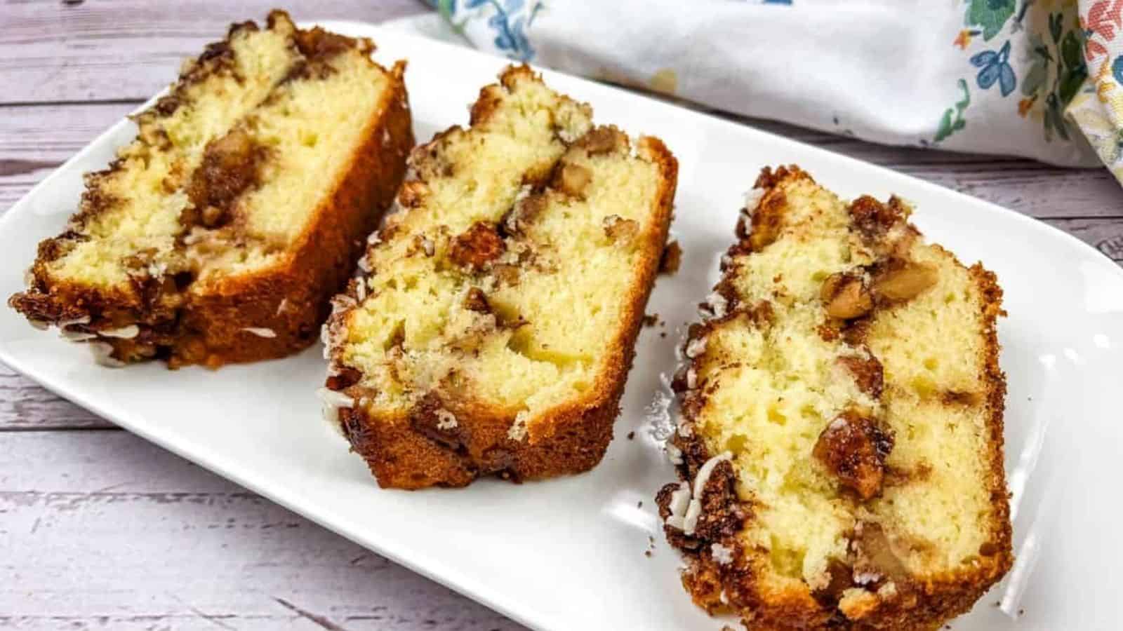 Three slices of apple fritter bread on a white plate.