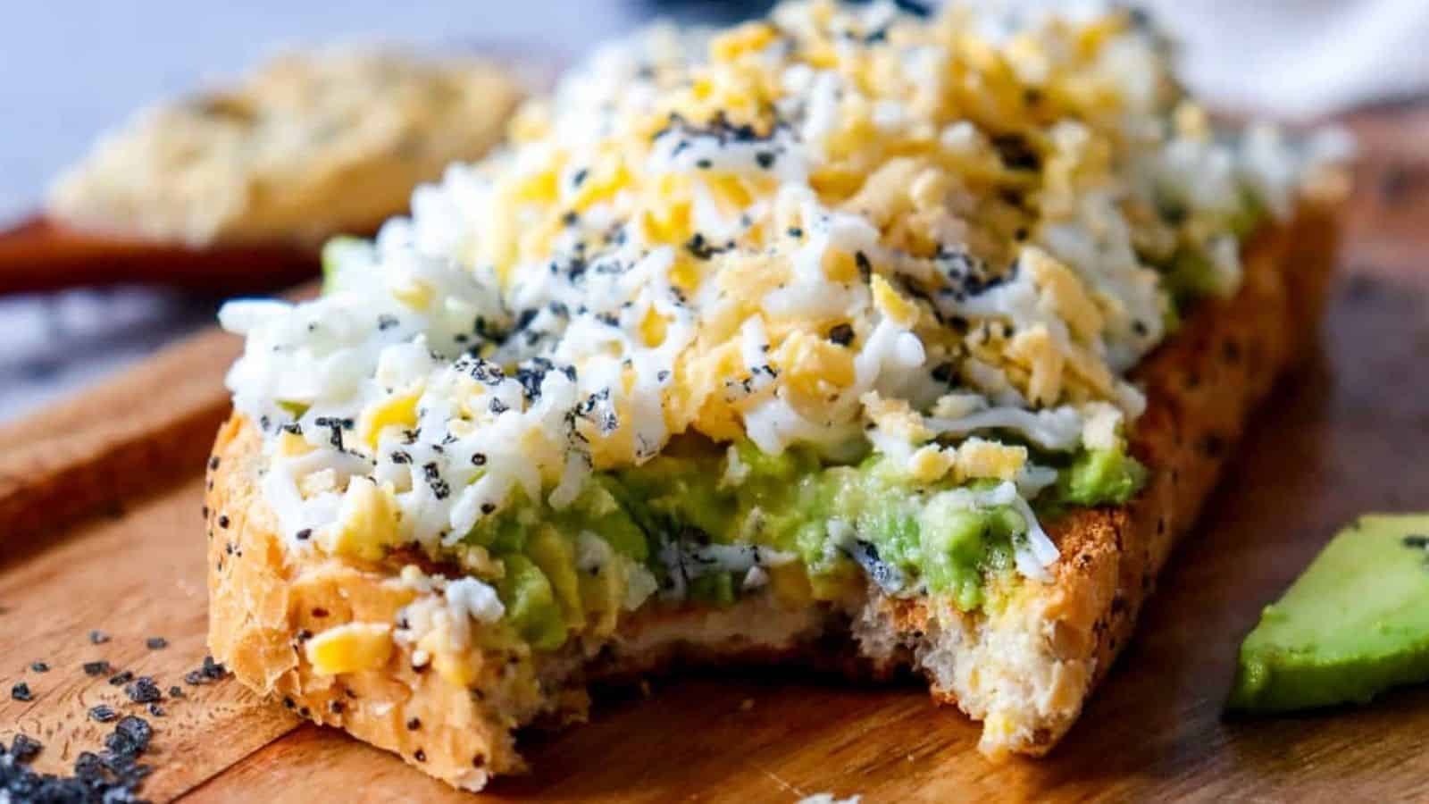 Avocado toast on a wooden cutting board.