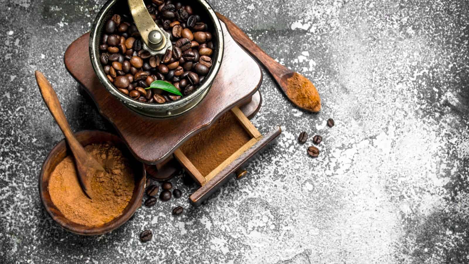 Overhead image of coffee grinder with coffee beans and grind cofee.