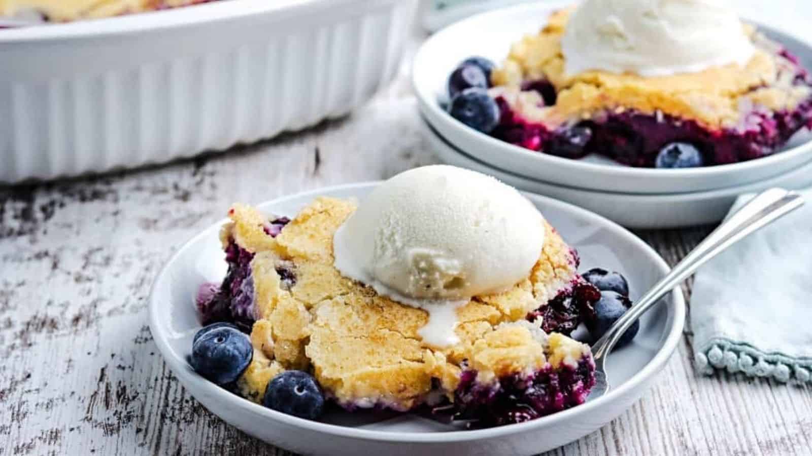 Blueberry cobbler topped with a scoop of vanilla ice cream.