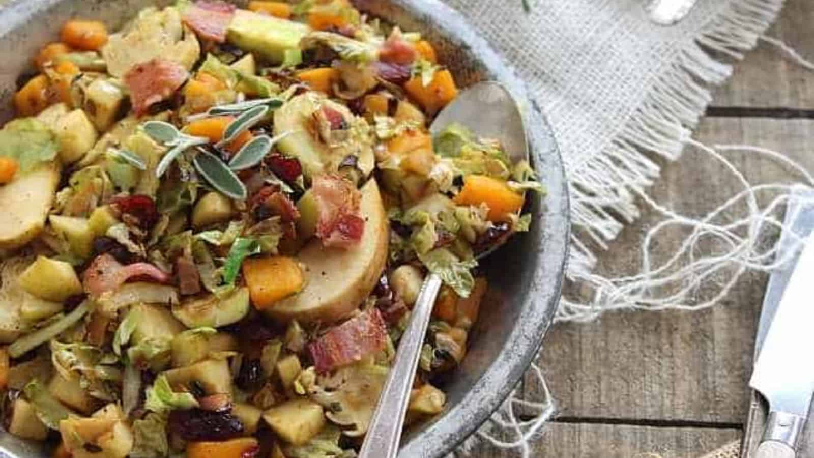 A close-up of Brussels Sprouts Pumpkin and Apple Hash on a plate with a spoon.