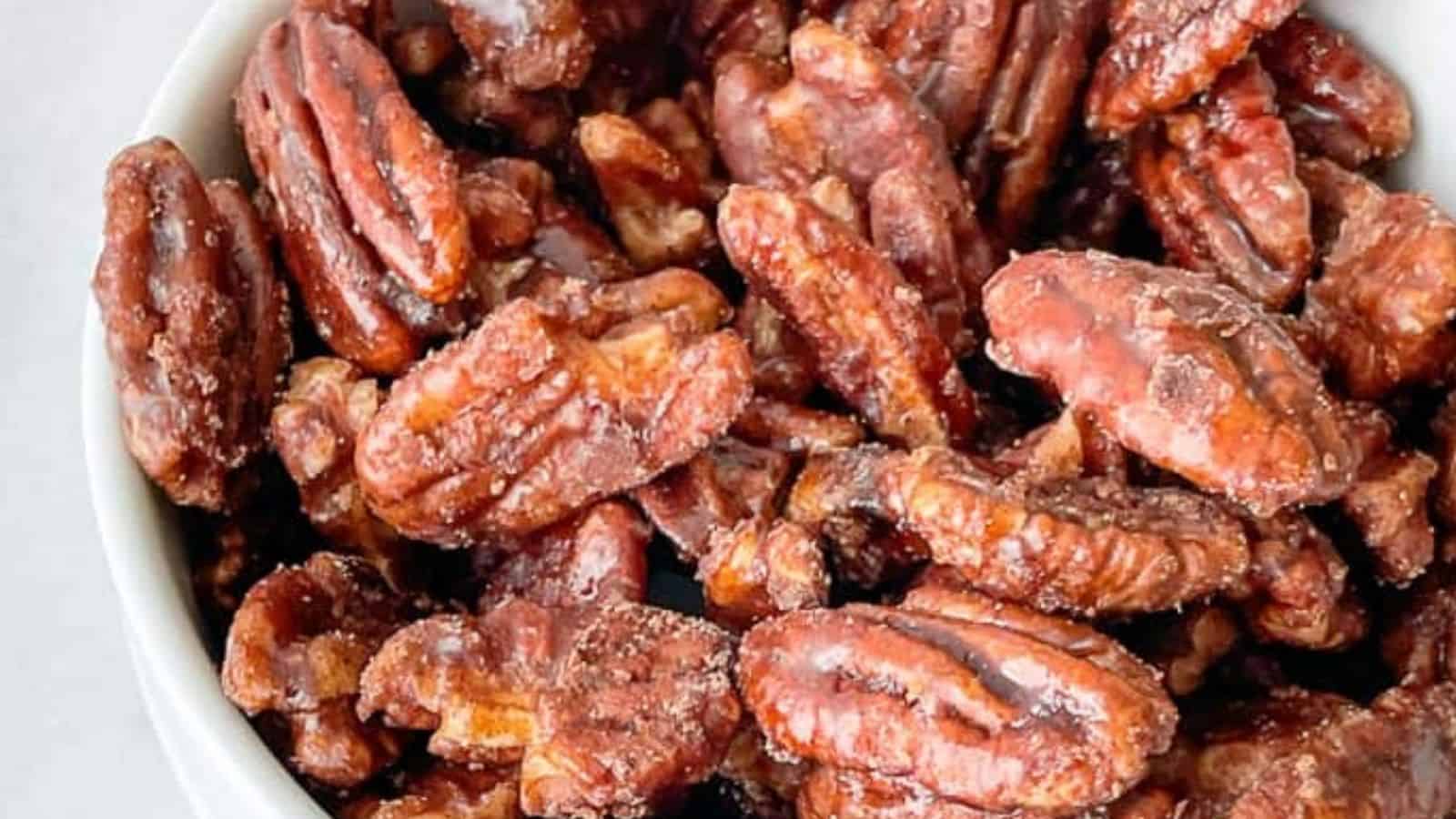 Close-up image of candied pecans in a bowl.