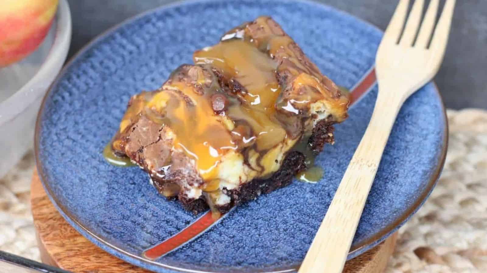 A piece of cake on a blue plate with a fork.