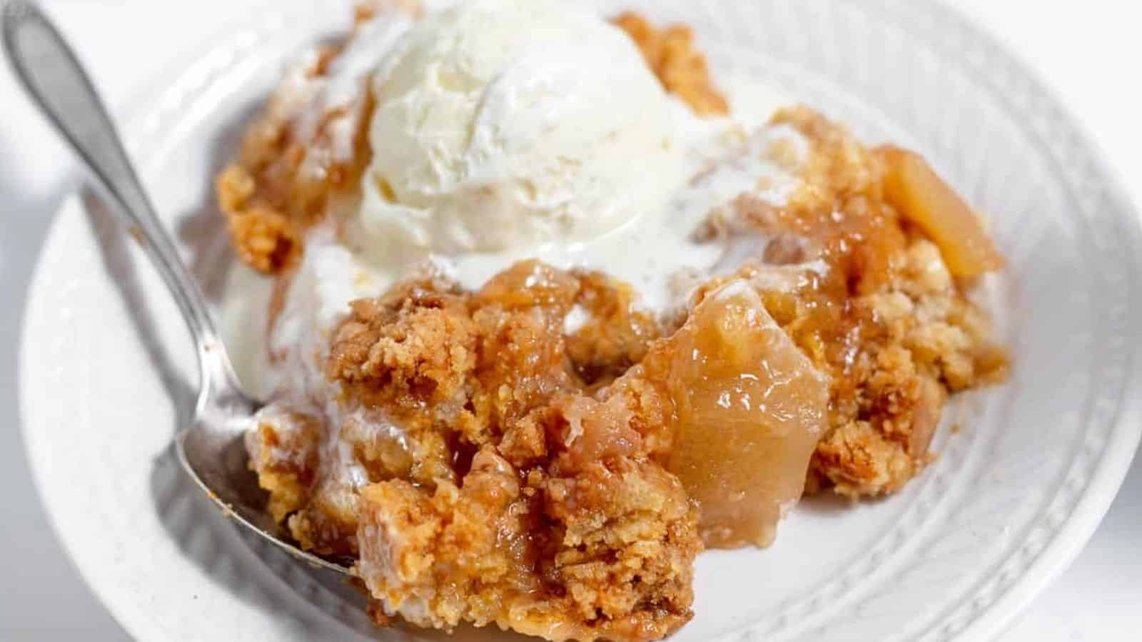 A bowl of cake with ice cream on top.