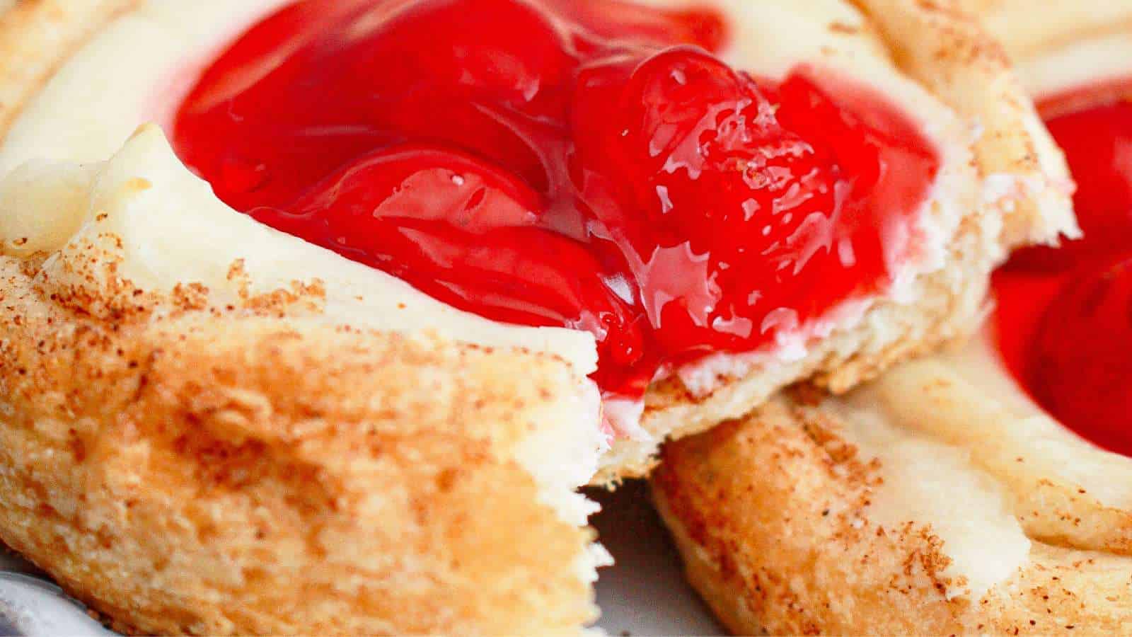 A close up of a cherry cream cheese crescent rolls Danish pastry.