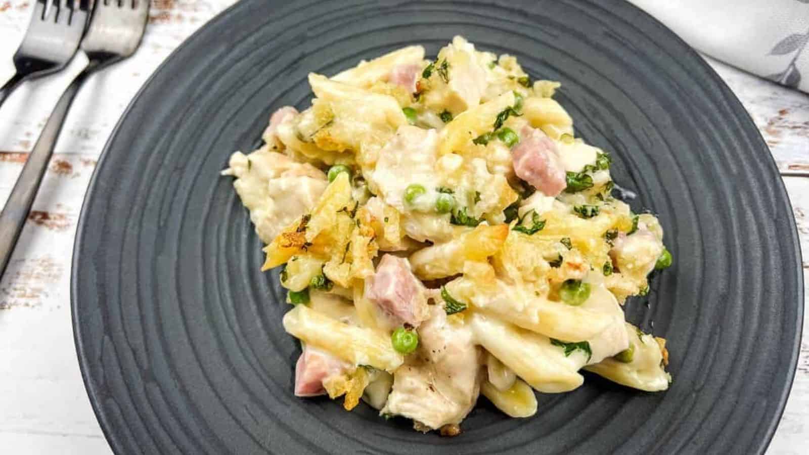 Chicken cordon bleu casserole on a black plate with a fork.