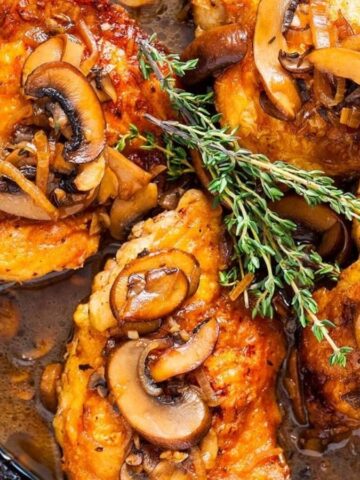 Overhead image of chicken thigh marsala in a pan.