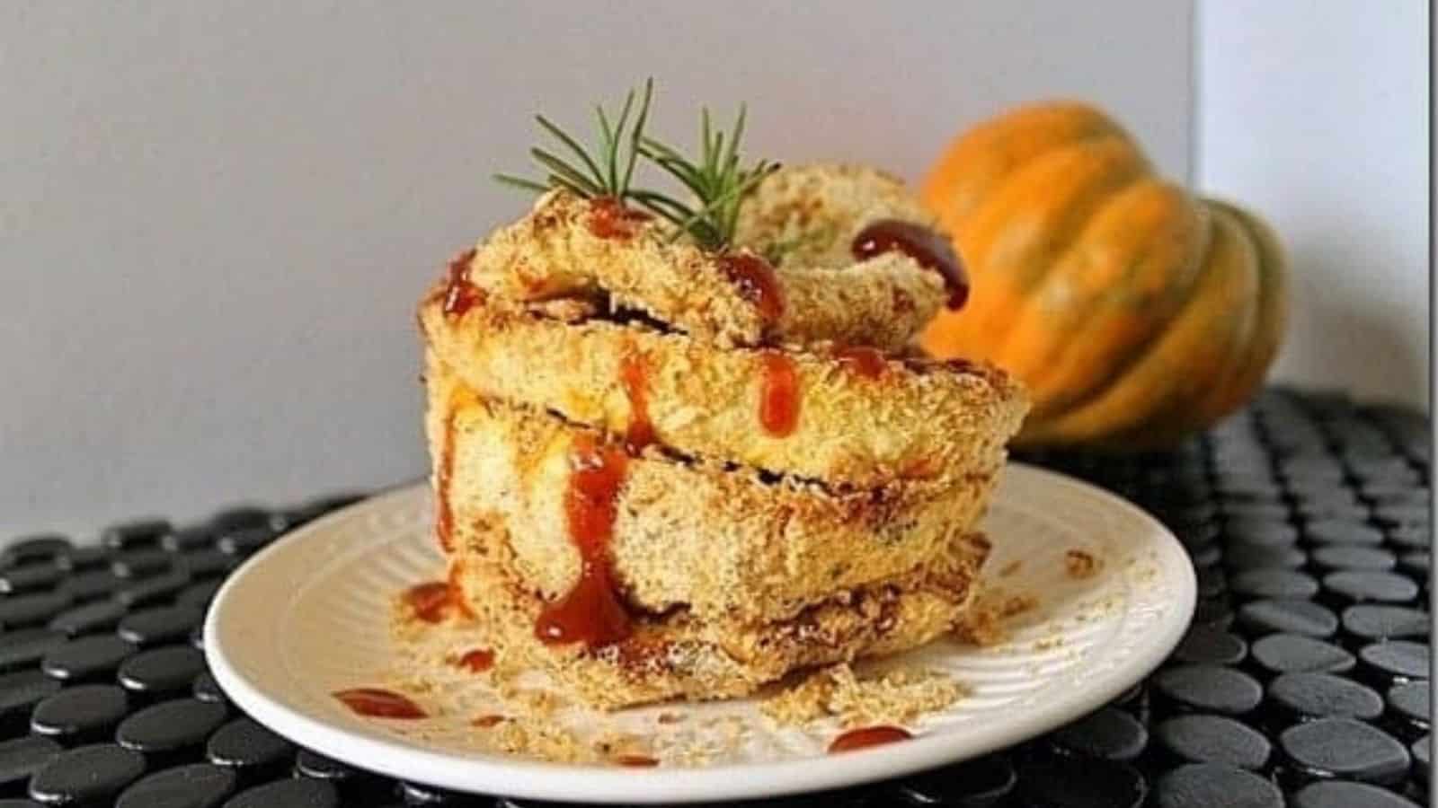 Coconut crusted acorn squash on a plate.