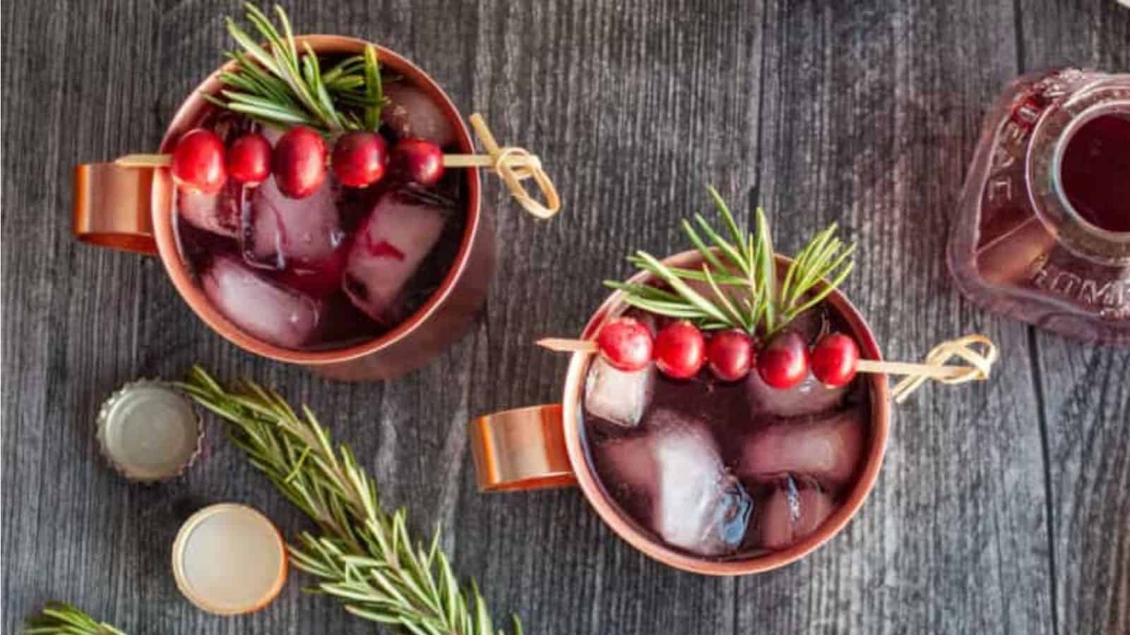 Overhead image of cranberrry moscow mule with ice in mugs.