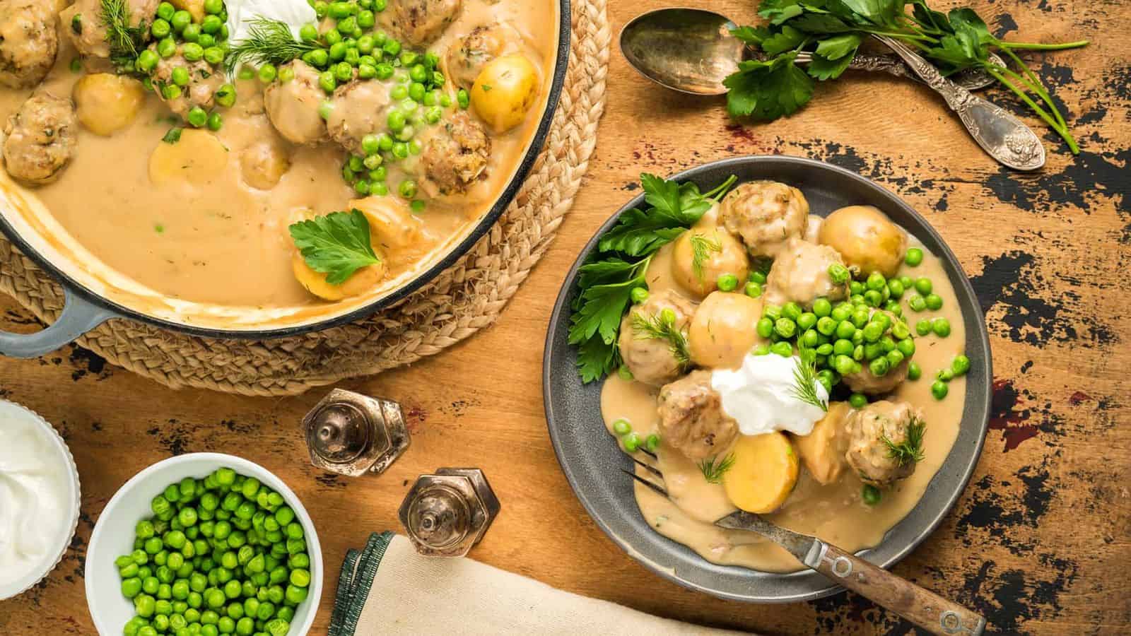 A bowl of Creamy Meatball Stew with peas.