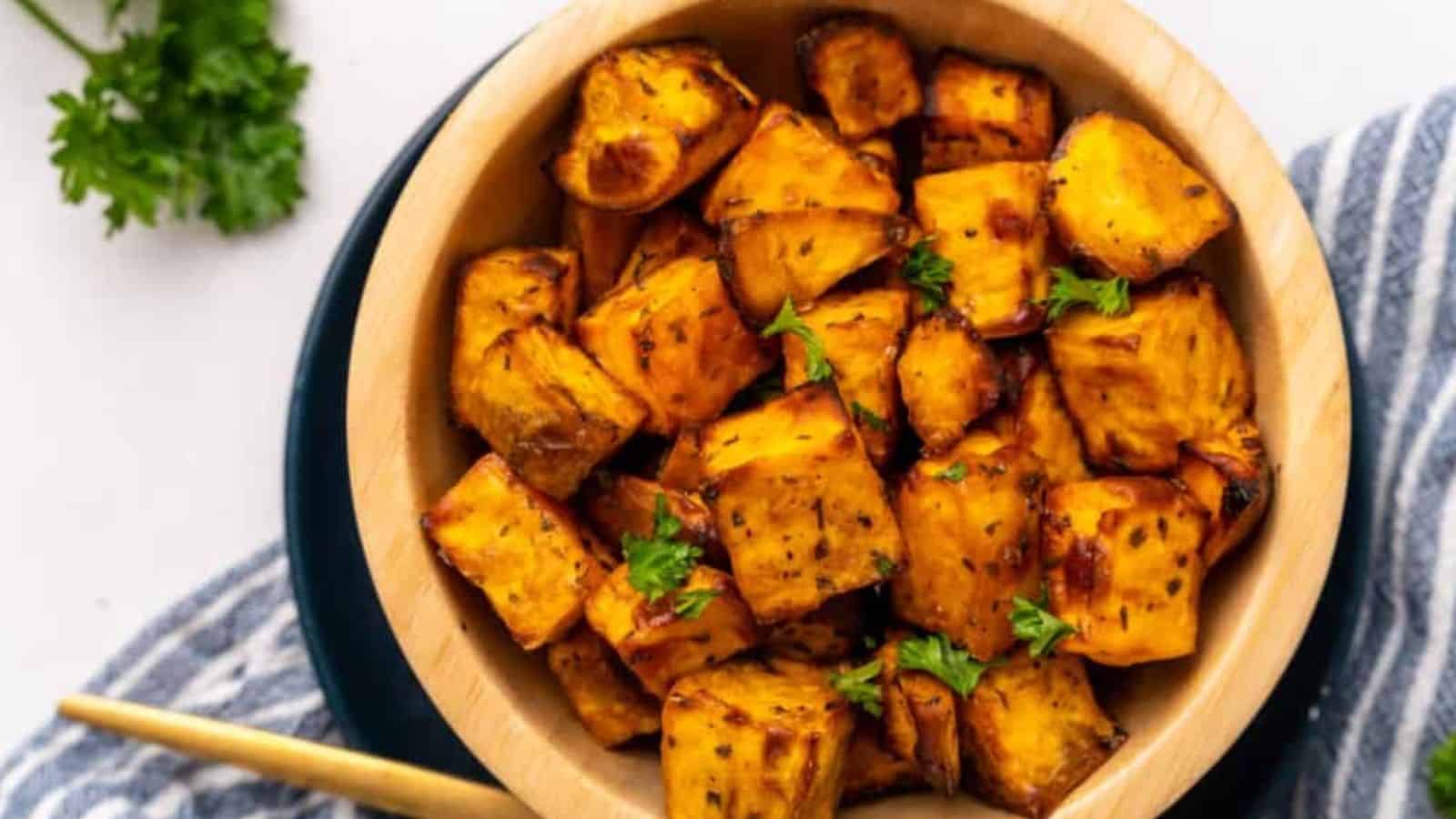 Overhead image of air fryer sweet potatoc ubes in a bowl.