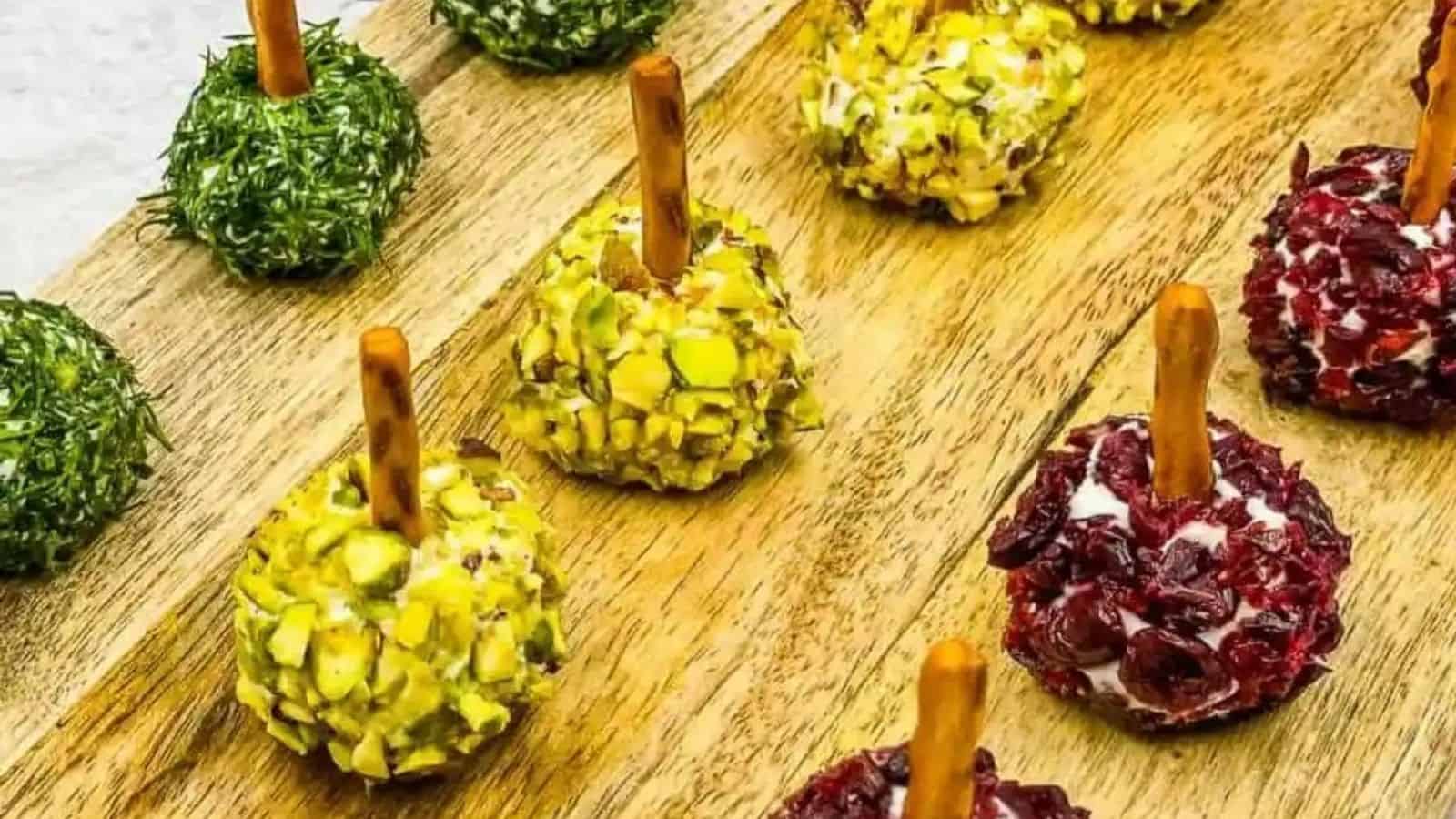Close-up image of mini goat cheese balls on a wooden board.