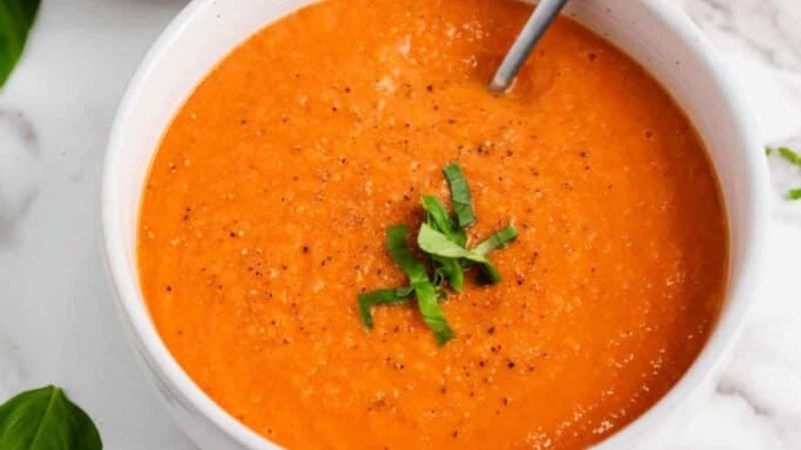 Close-up image of easy roasted tomato basil soup in a bowl.