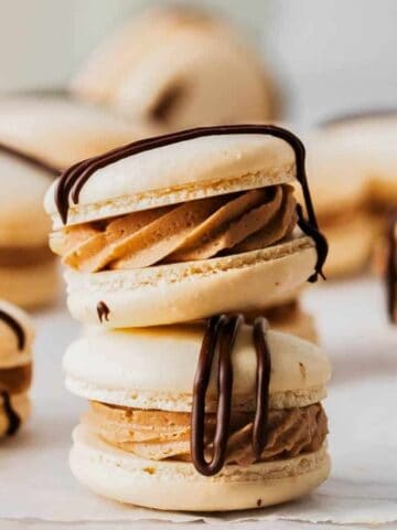 German chocolate macarons with chocolate ganache drizzle.