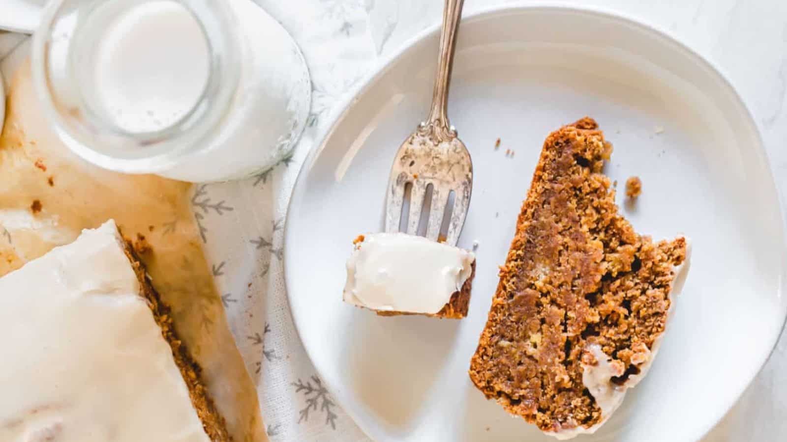 Overhead image of a slice of banana bread with maple tahini glaze on a plate.