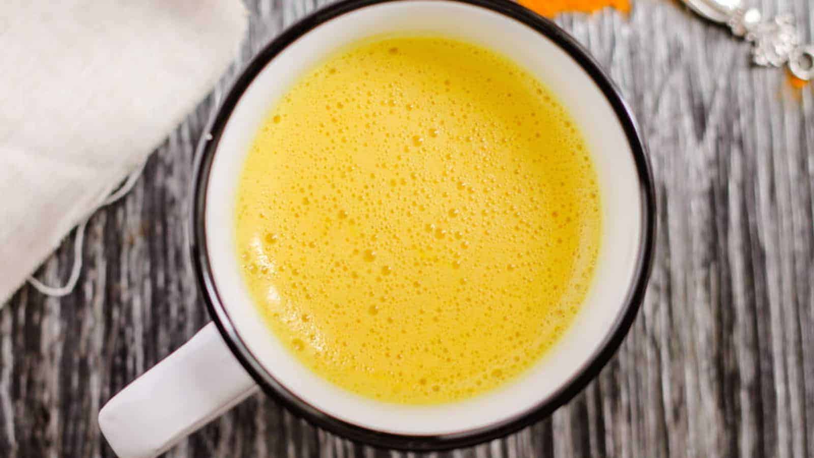 An overhead image of a mug of golden milk latte.