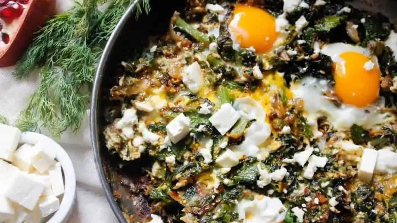 Close-up image of green shakshuka and the ultimate israeli breakfast in a pan.