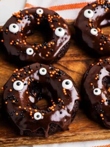 Chocolate Cake Mix Donuts decorated for halloween with frosting and sprinkles.