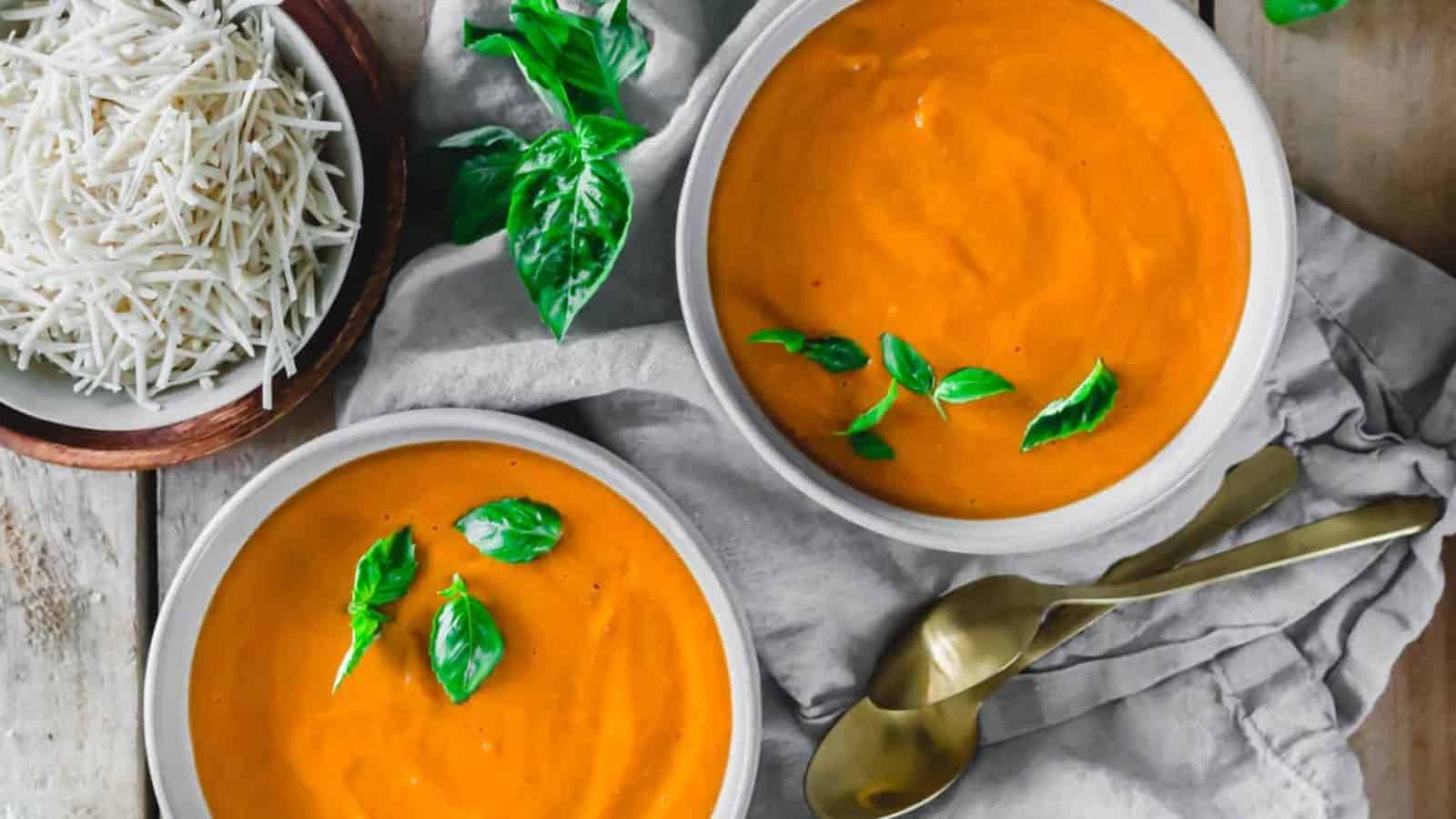 Top view of 2 bowls of homemade tomato soups.