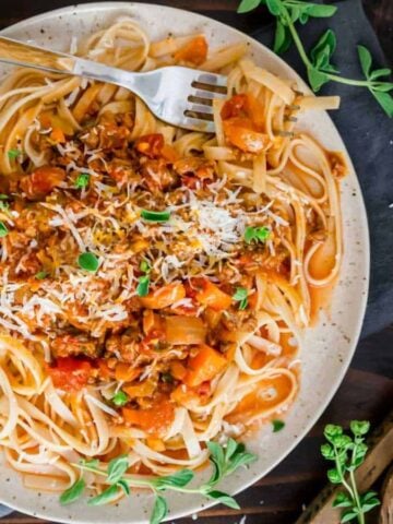 A plate of Instant Pot Bolognese with a fork.