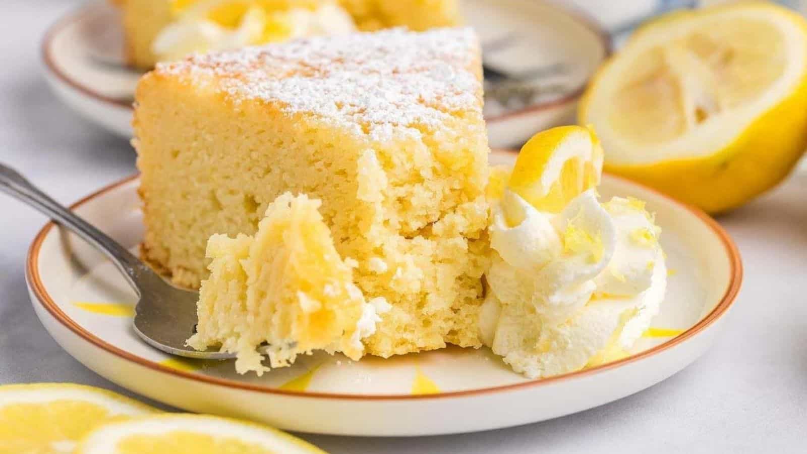 A slice of italian lemon ricotta cake with a spoon on a plate.
