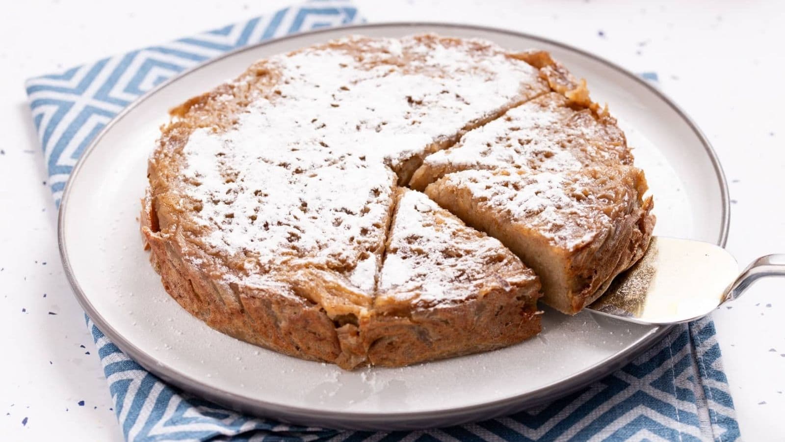 An image of Jamaican sweet potato pudding being sliced.