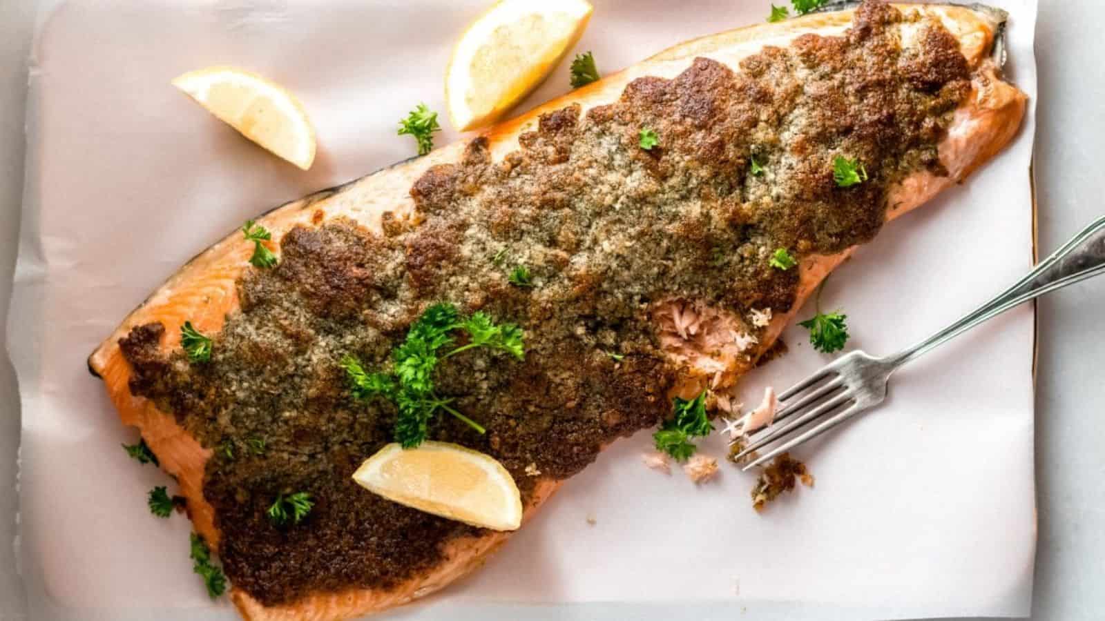 Keto baked parmesan salmon on foil on a baking sheet.