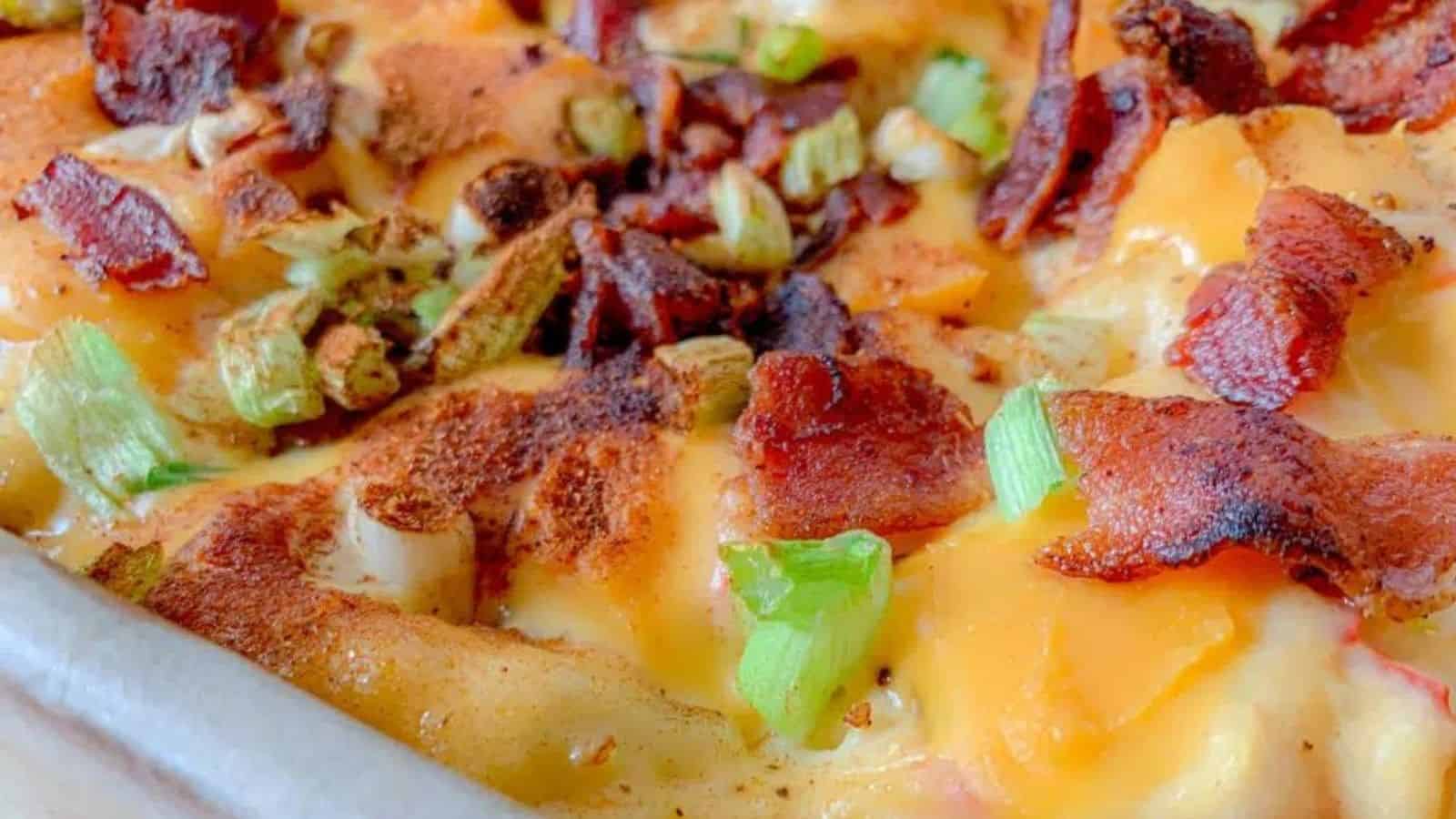 Close-up image of loaded german potato bake in a dish.