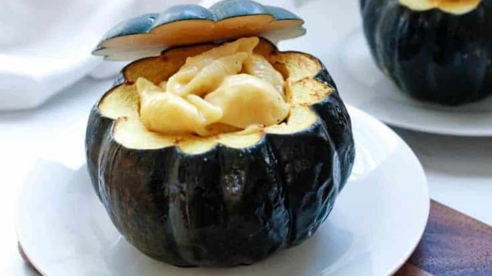 Macaroni and cheese stuffed acorn squash on a plate.