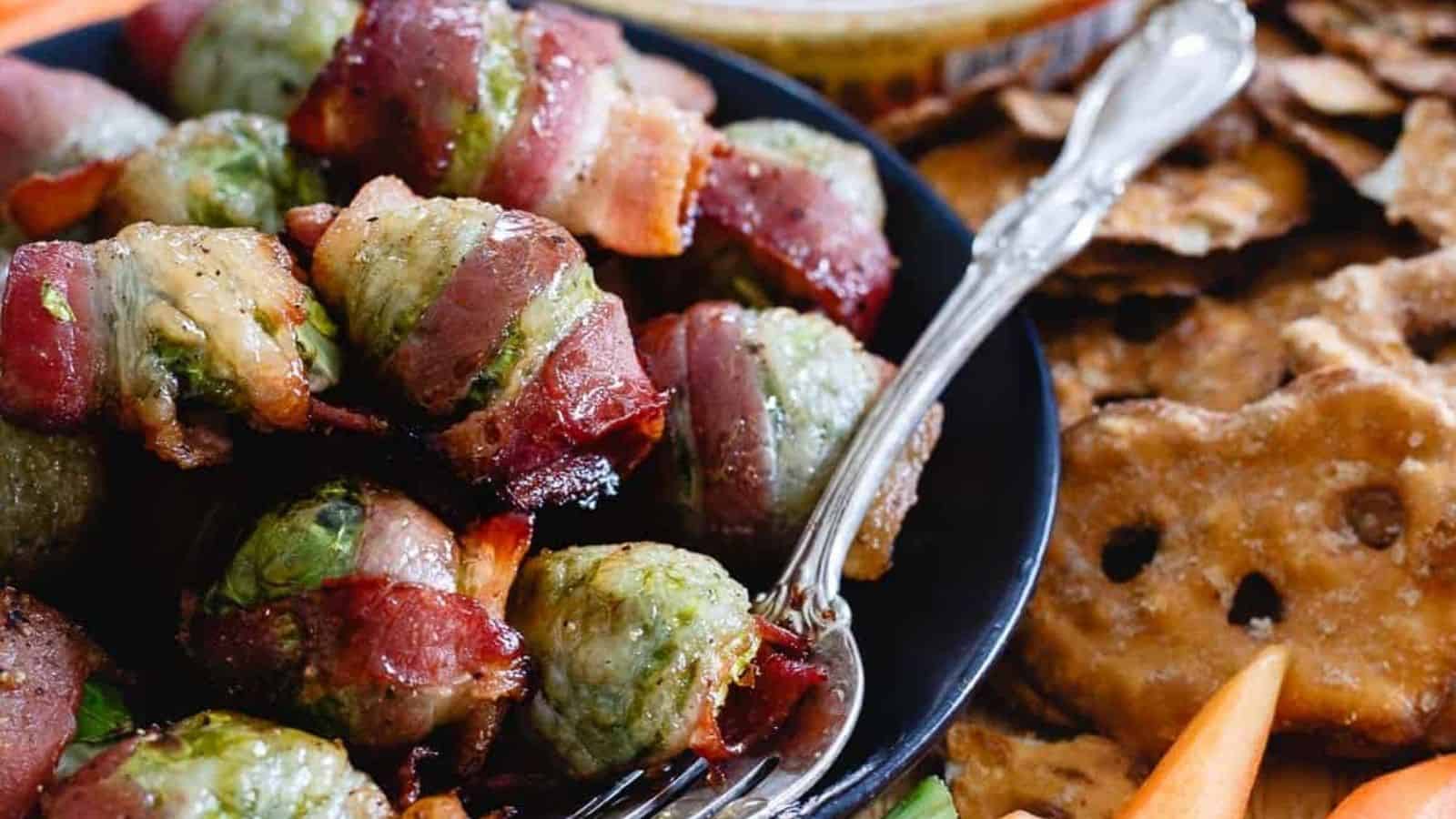 Close-up image of maple bacon wraoped brussel sprouts with a frok on a plate.