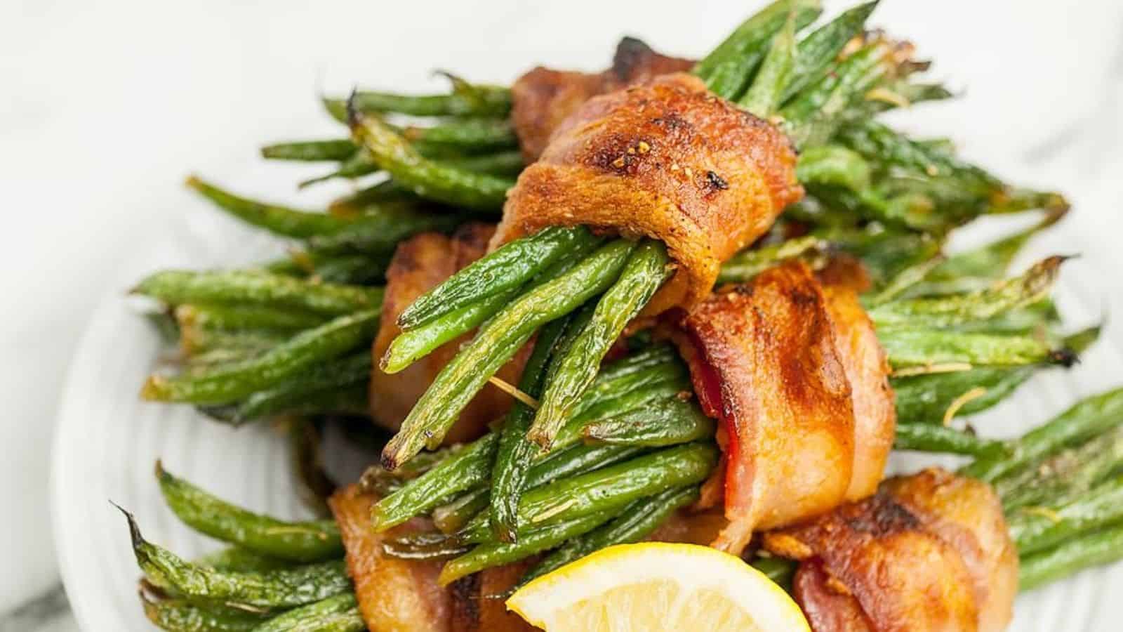 Close-up image of maple bacon wrapped green bean bundles on a plate.