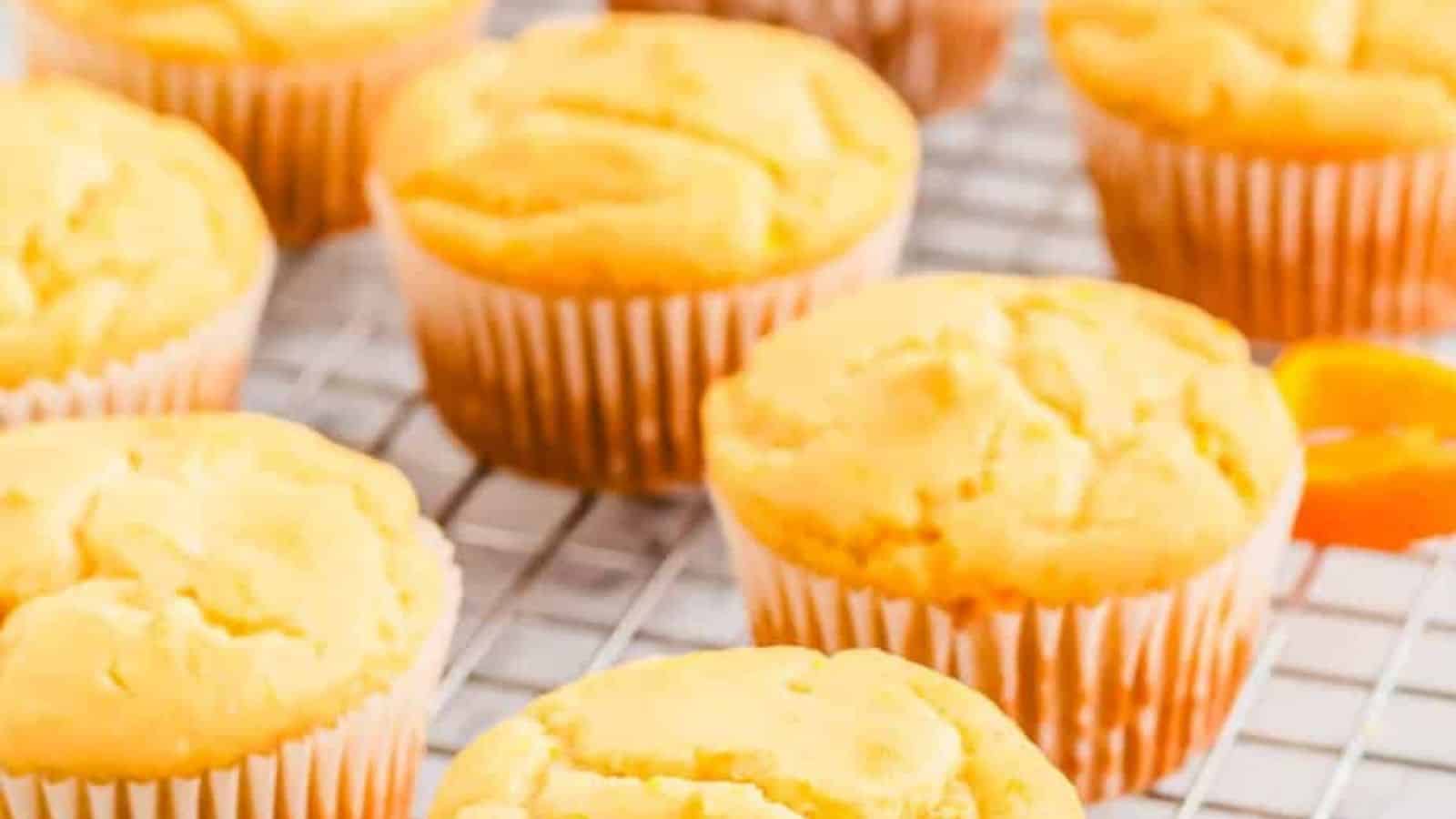 Orange muffins on a cooling rack.