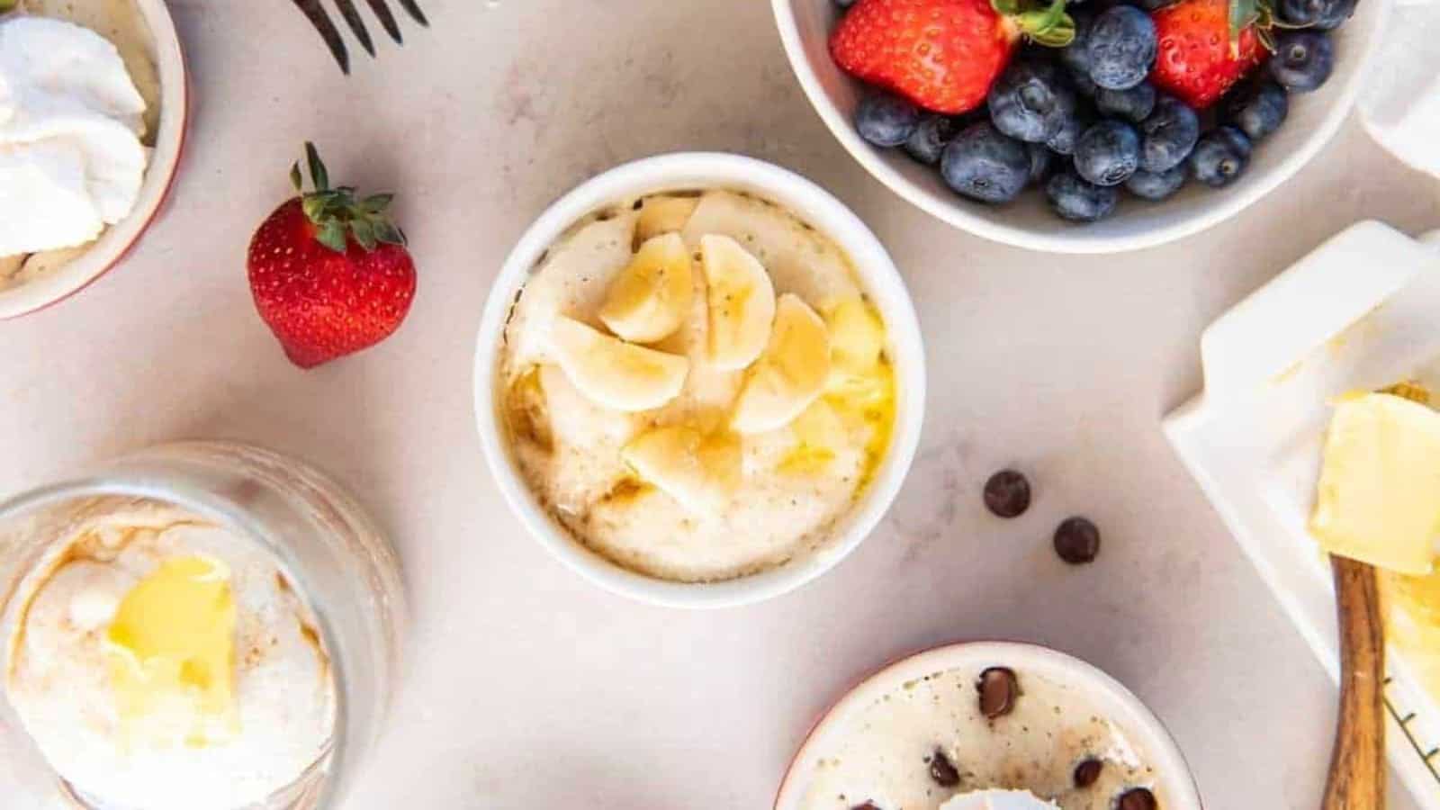 Pamcakes in mugs with fresh fruits.