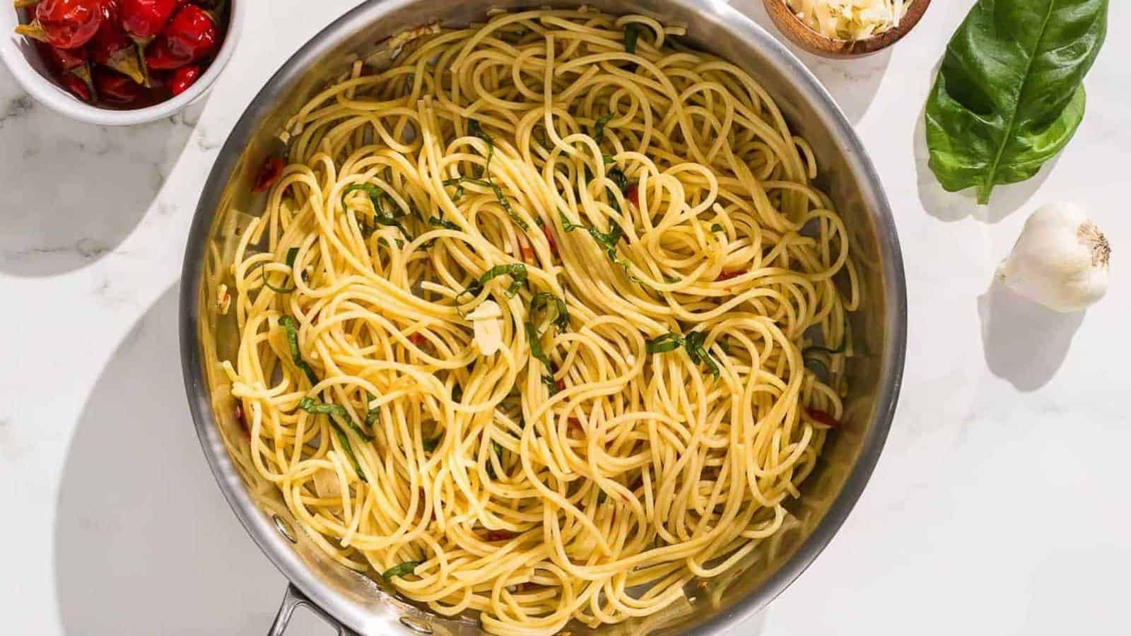 pasta aglio olio e peperoncino is mixed with a black pasta fork.