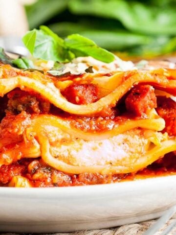 A slice of Pepperoni Lasagna on a white plate.
