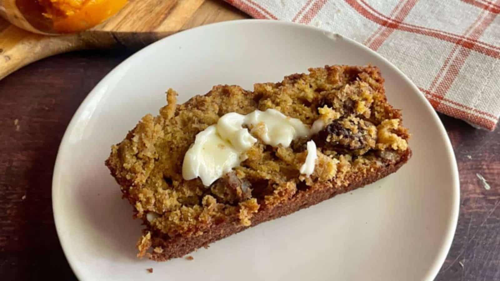 A slice of pumpkin banana bread on a white plate.