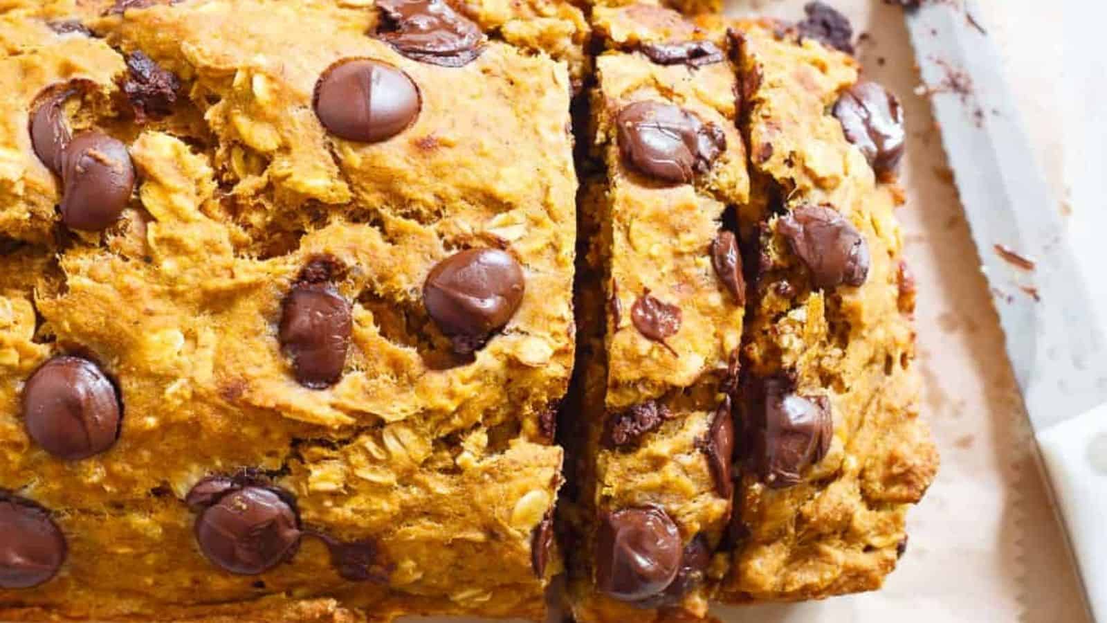 Close-up image of pumpkin banana chocolate chip bread with a bread knife.