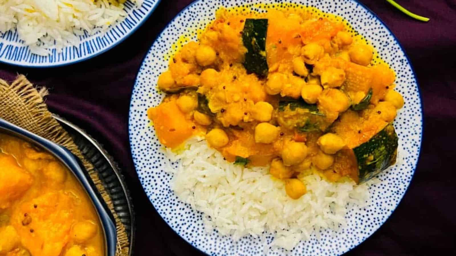 Overhead image of pumpkin chickpea curry with coconut milk with rics on a plate.