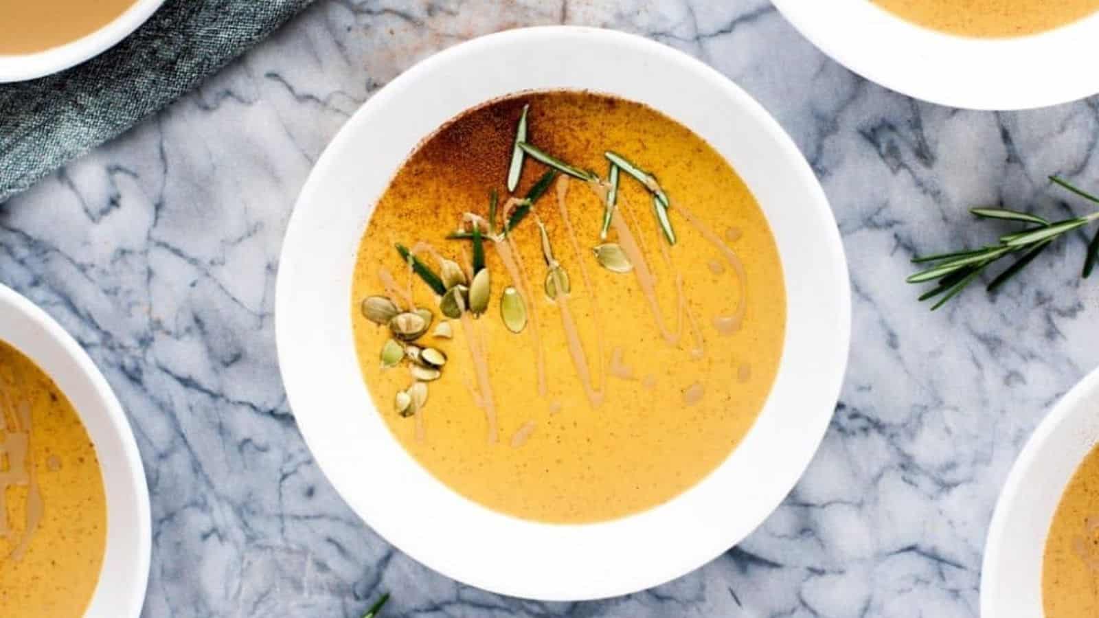 Overhead image of various bowls of pumpkin soup with canned pumpkin.